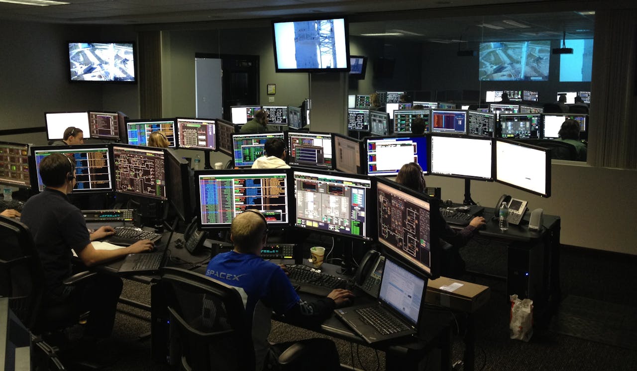 Centralized control room with multiple monitors displaying building systems